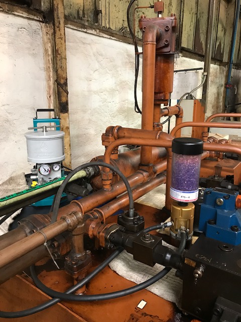 Inline oil filter mounted on industrial piping