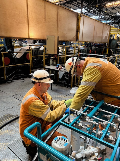 Technicians servicing a mobile filtration unit