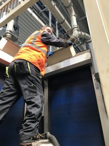 Technician servicing an industrial filtration system