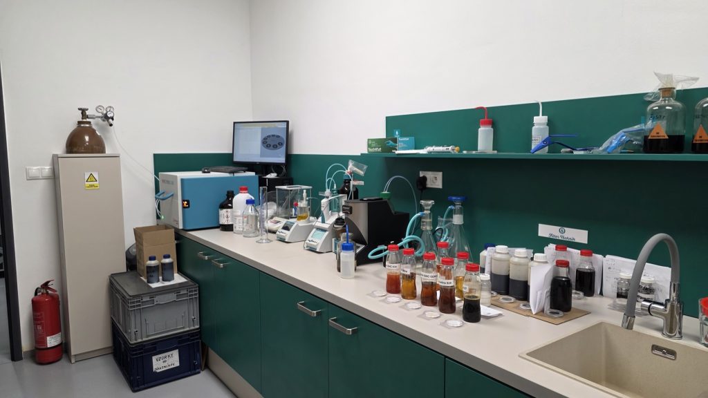 Laboratory workspace with analytical instruments and oil samples